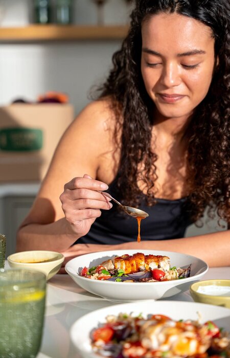 Model enjoying food and smiling