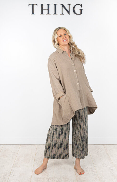 Model in flowing shirt and trousers in studio