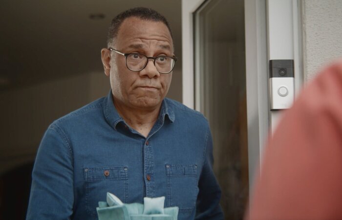 Male actor looking confused at door