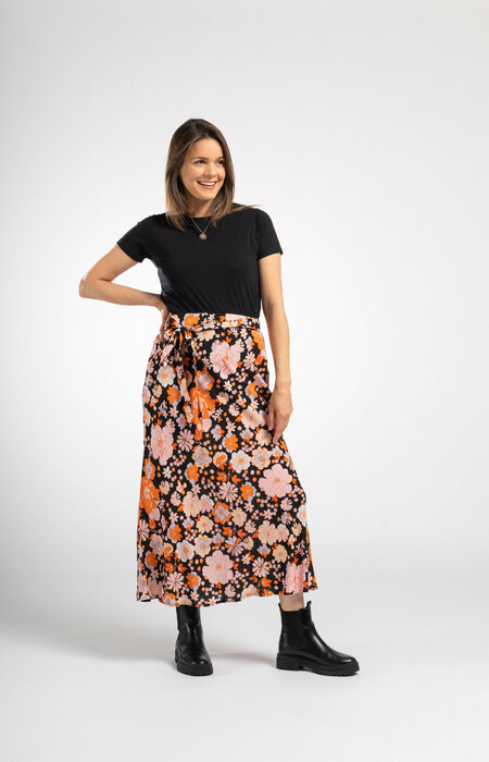 Model in studio black t shirt and skirt