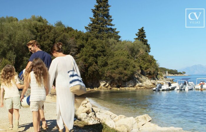 Family on holiday walking by the sea