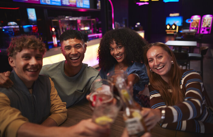 Friends at table drinking together