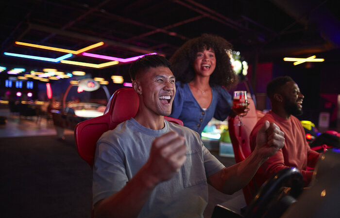 Friends playing in arcade together