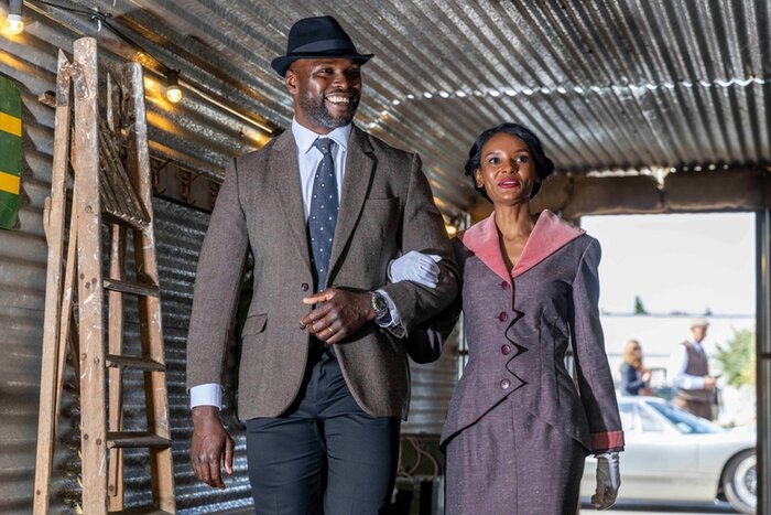 Model couple in vintage clothing arm in arm