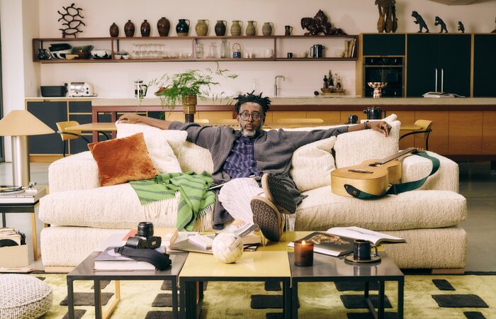 Man sat spread out on big sofa