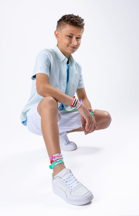 Junior model crouching showing wristbands