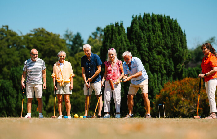 Group of classic models playing croquet