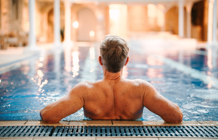 Back shot of male classic model in swimming pool