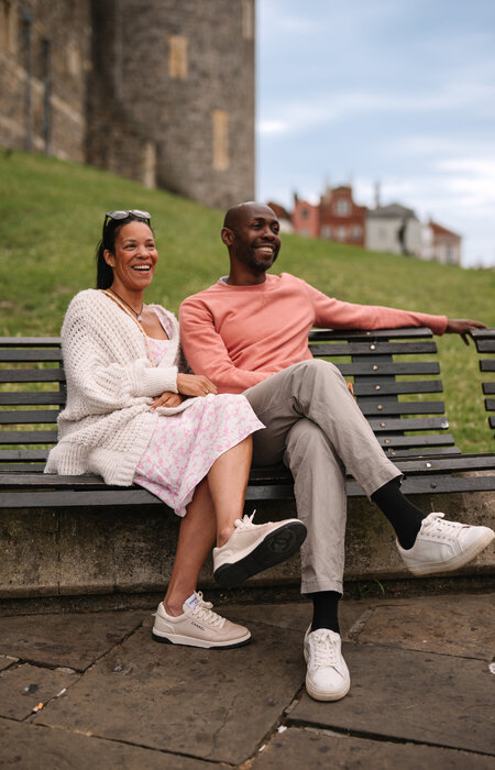 Classic model couple sat on a bench happy
