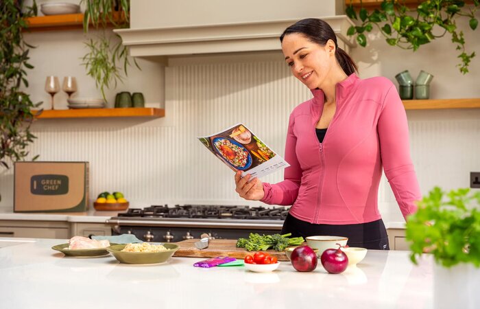 Model reading recipe card in the kitchen