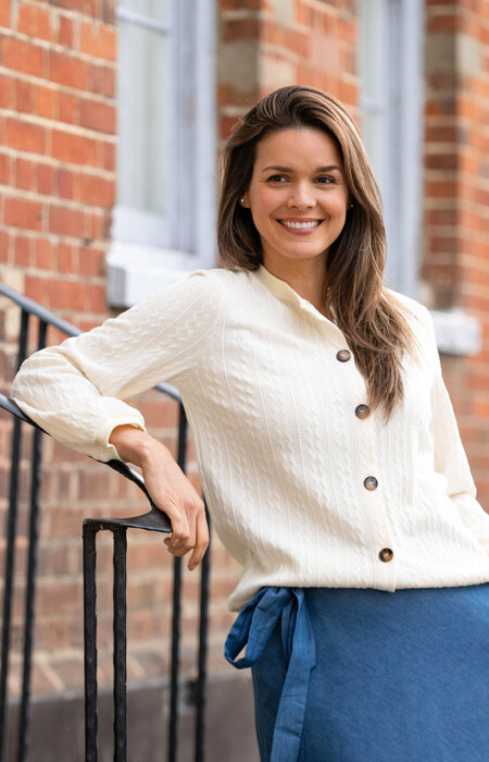 Model smiling and leaning on stairs