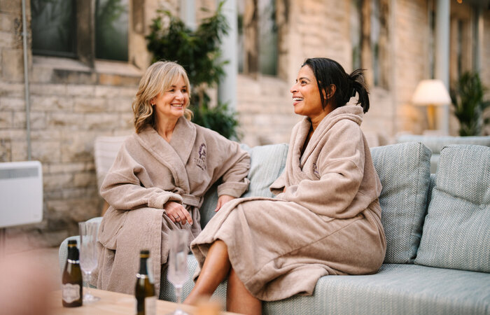 Two female models in bath robes at the spa