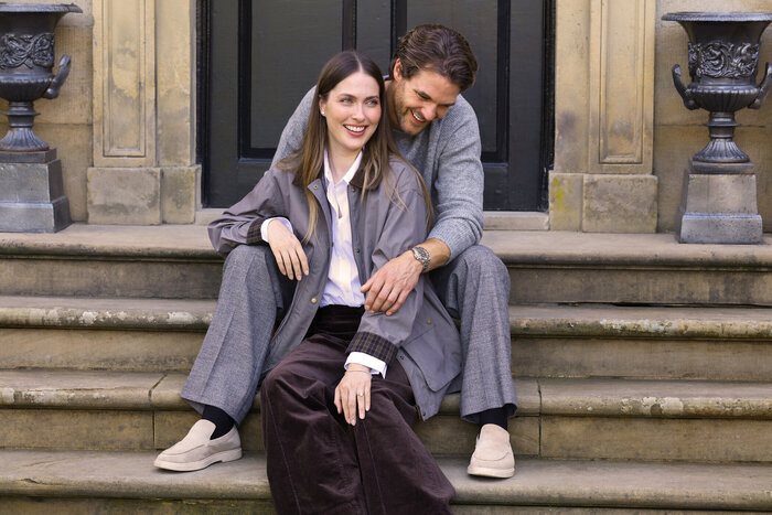 Model couple sat on steps together