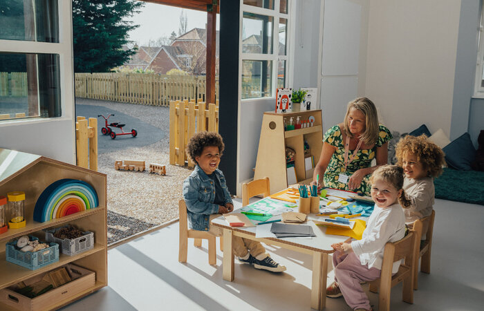 Children at table with teacher