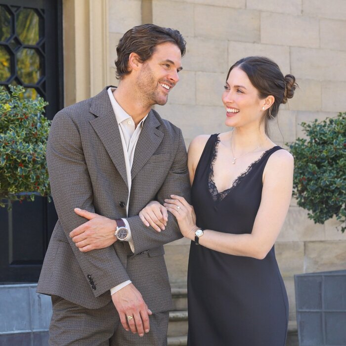 Model couple smiling arm in arm