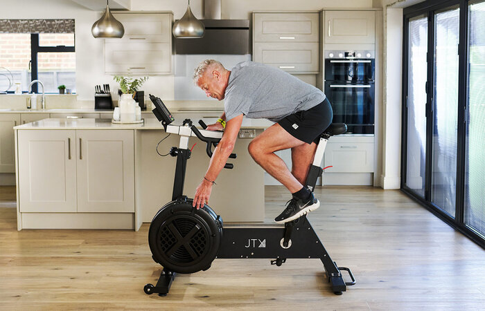 Male classic model on exercise bike