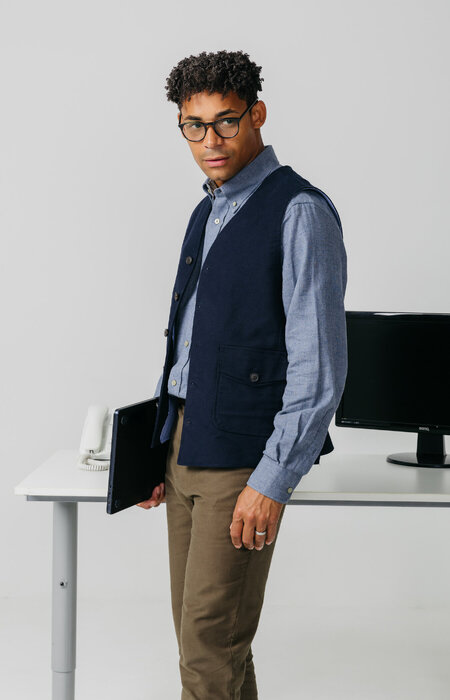 Male model by desk wearing glasses