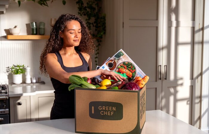 Model unpacking recipe box in kitchen