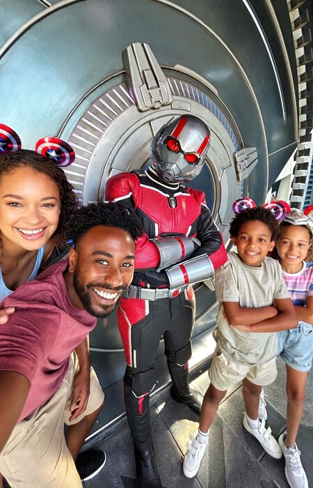 Family posing for photo smiling at Disneyland