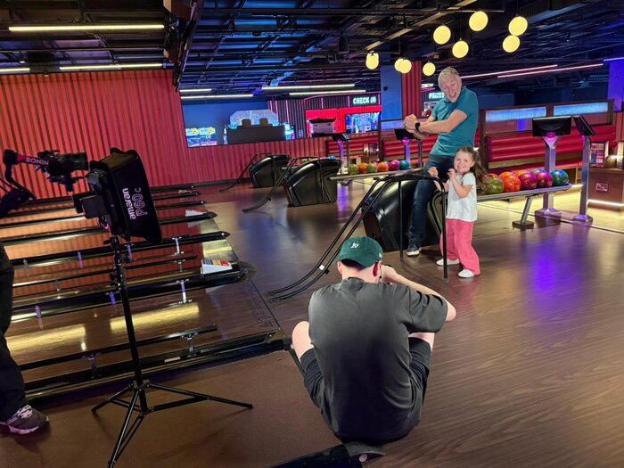 Behind the scenes shot of junior model bowling