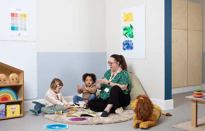 Children laughing with their teacher