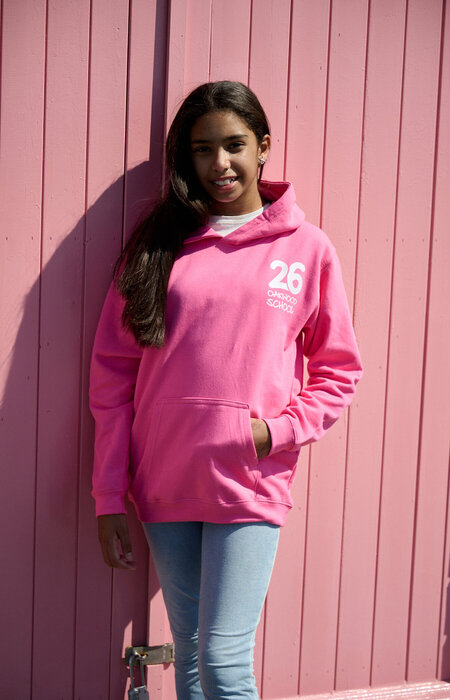 Junior female model in hoodie by beach huts