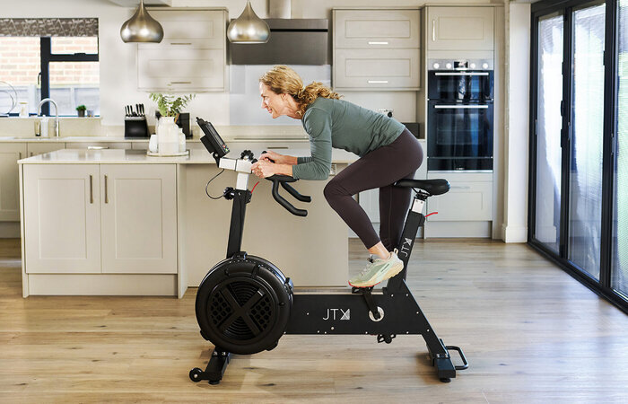 Female classic model on exercise bike