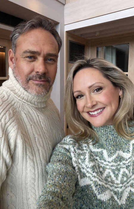 Model couple wearing sweaters and smiling