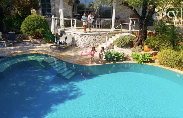 Family on holiday at big villa with pool
