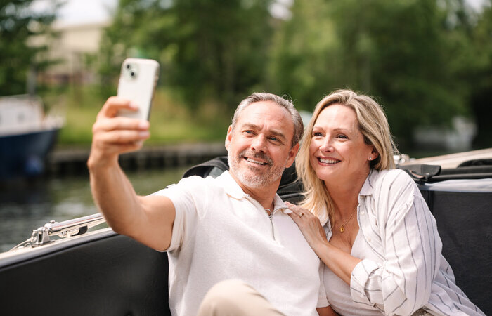 Classic couple in boat taking selfie