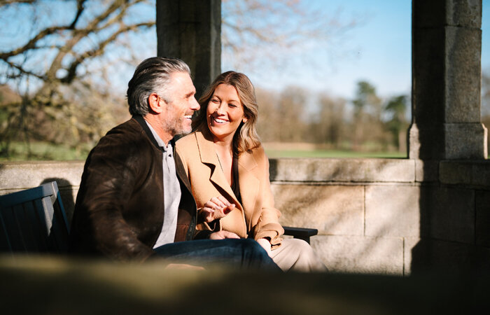 Couple laughing on bench