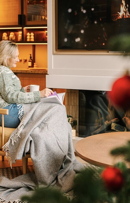 Classic model relaxing and reading by fire