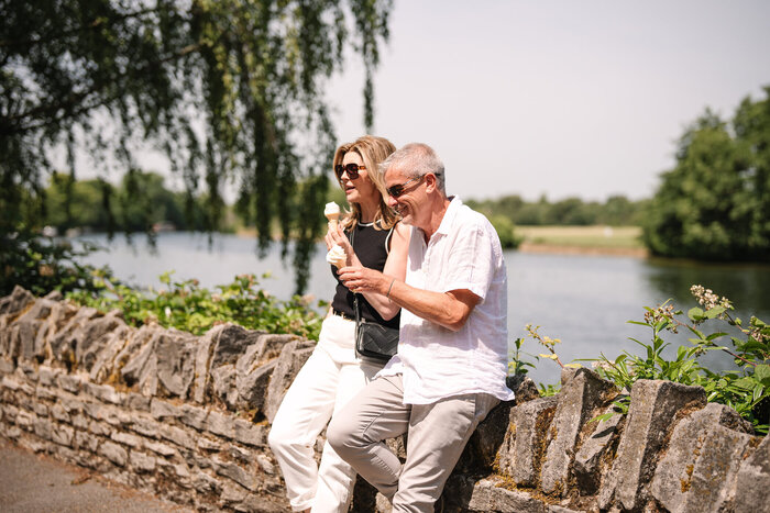 Classic model couple eating ice creams by river