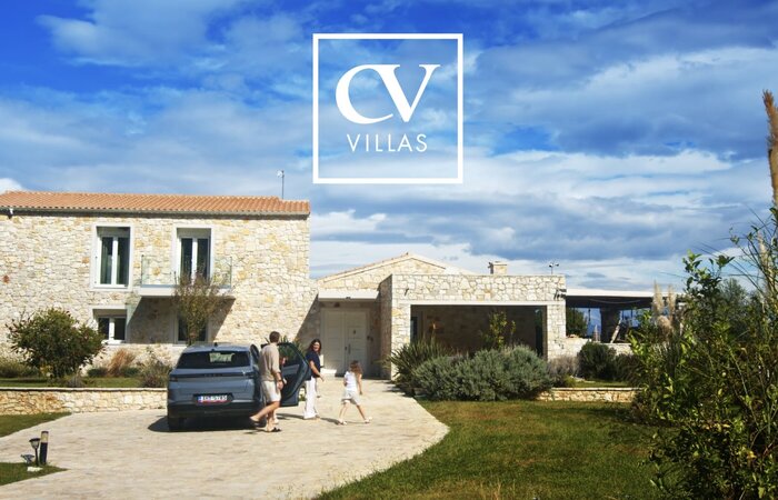 Family getting out of car walking towards villa