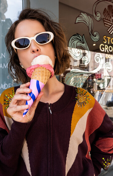 Model wearing sunglasses eating ice cream
