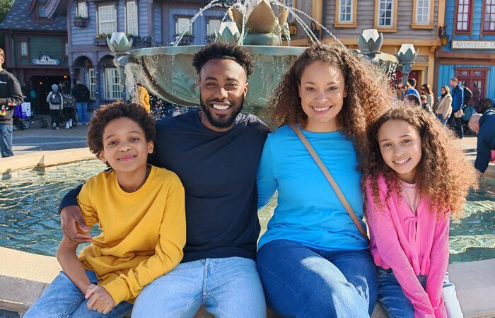 Model family sitting together at Disneyland
