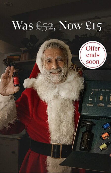 Classic male model with white beard in santa outfit