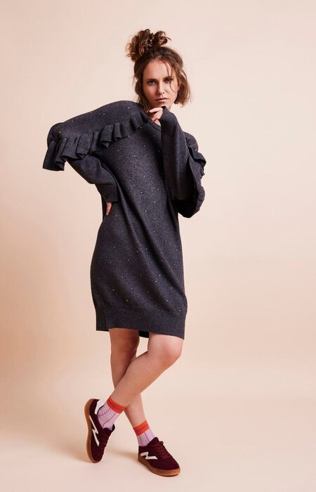 Model leg crossed standing studio shot