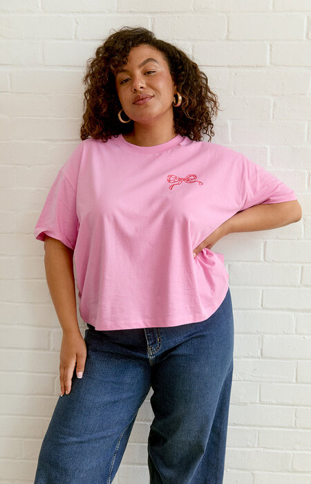 Curve model in bright pink t shirt and jeans
