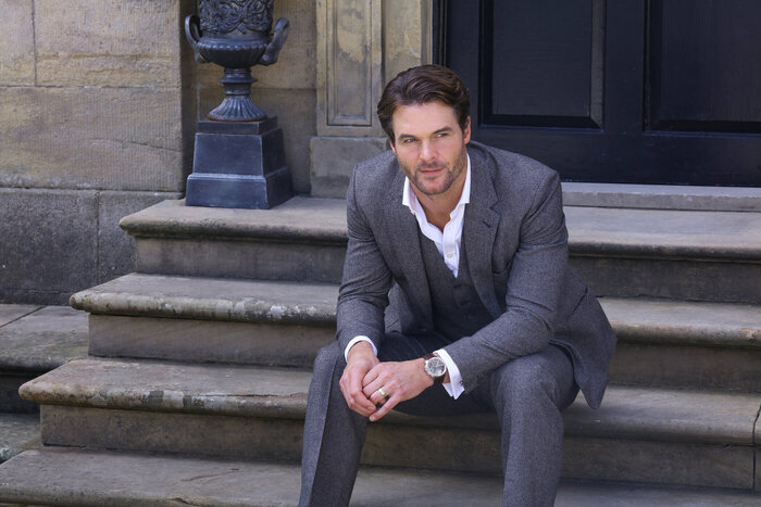 Male model sitting on steps in suit