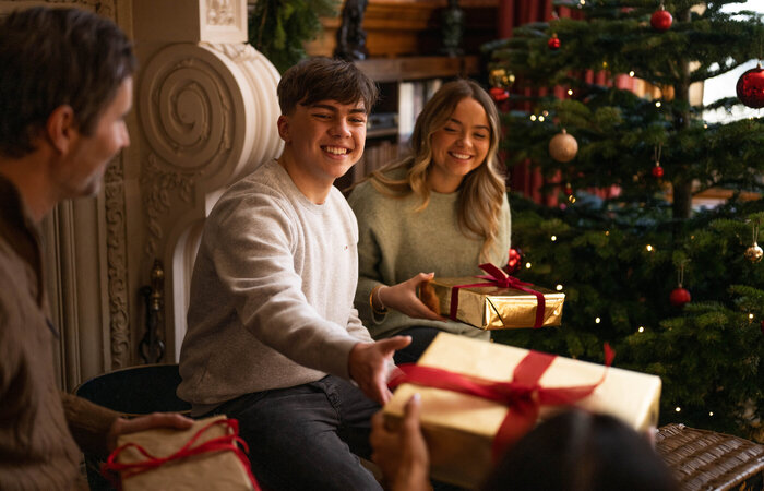 Model family exchanging gifts