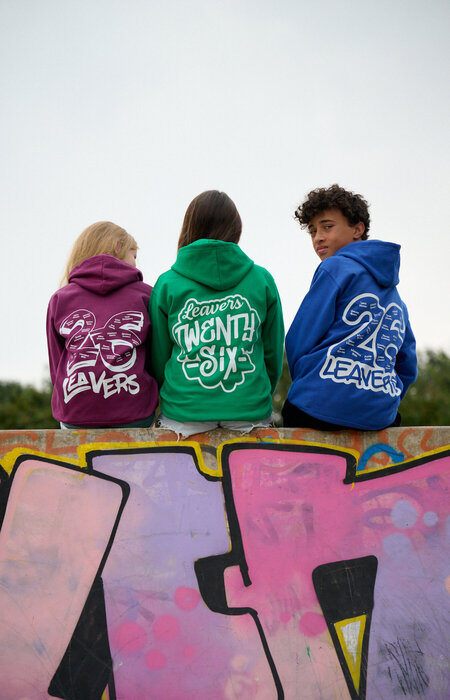 Three junior models showing design on backs of hoodies