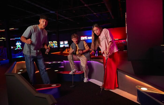 Friends playing mini golf together
