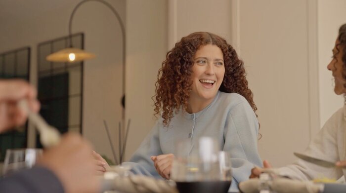 Model Mum laughing at dining table