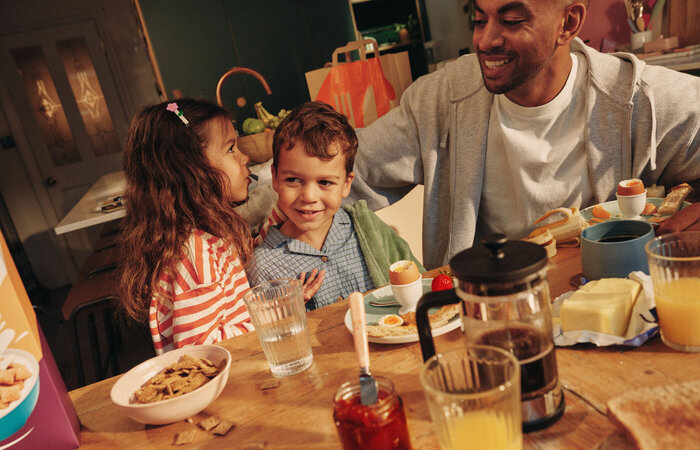 Model Dad and children having breakfast