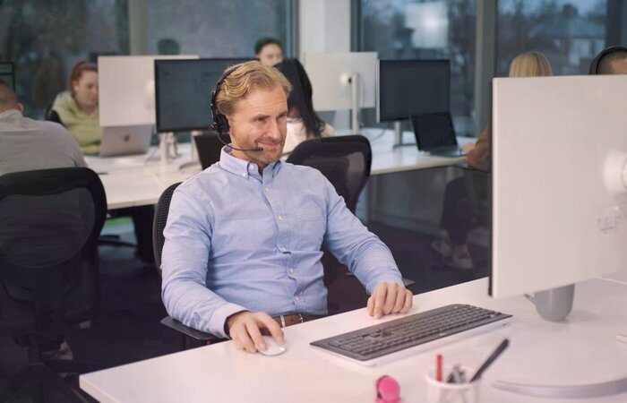 Actor sat at office desk