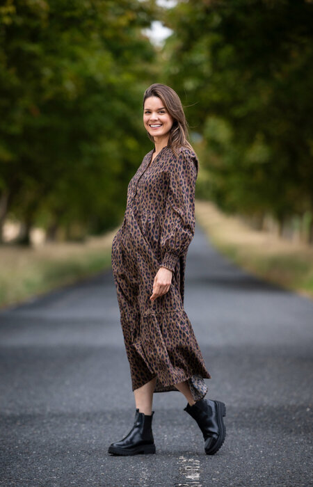 Model in dress standing smiling