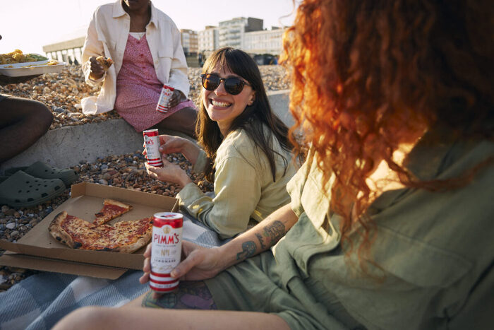 female model smiling with friends on beach