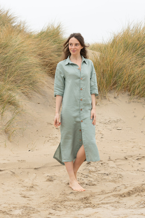 Model on beach in linen dress
