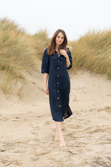 Model on beach in navy dress